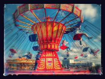 Low angle view of ferris wheel against sky