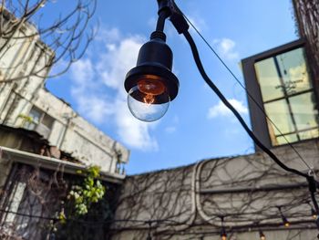 Low angle view of street light against building