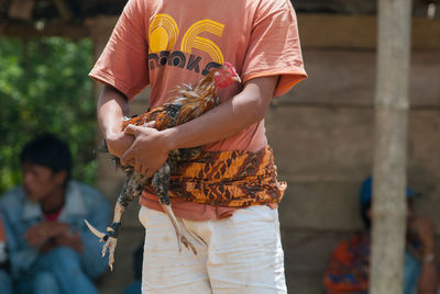 Midsection of man holding ice cream cone