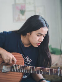 Young woman playing guitar