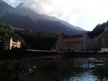 Scenic view of river and mountains against sky