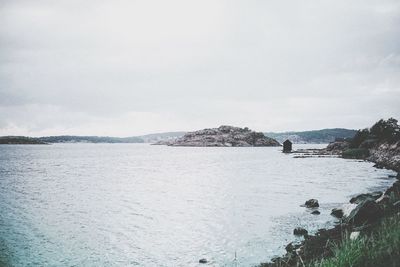 Scenic view of sea and mountains against sky