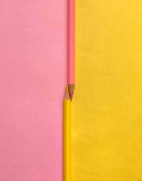 Close-up of colored pencils against wall