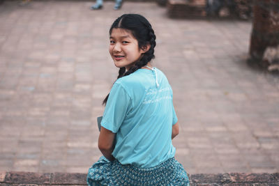 Portrait of smiling girl standing outdoors