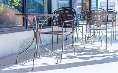 Empty chairs and tables in snow