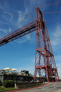 Low angle view of crane against blue sky