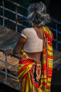 Rear view of woman with multi colored umbrella