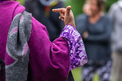 Close-up of woman holding pink flowers