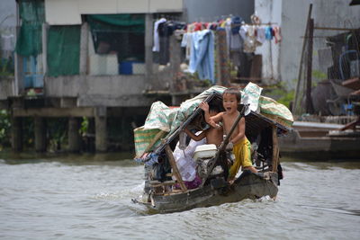 Rear view of man sitting in water