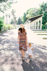 Rear view of women walking on walkway