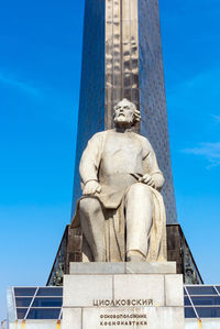 Low angle view of statue against blue sky
