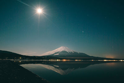 Scenic view of landscape against sky at night