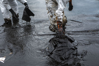 Low section of people walking in water