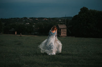 Full length of bride walking on grass