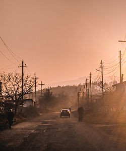 Car on road against sky during sunset