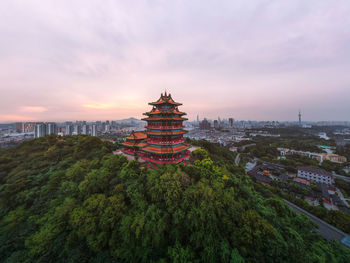 View of buildings in city at sunset