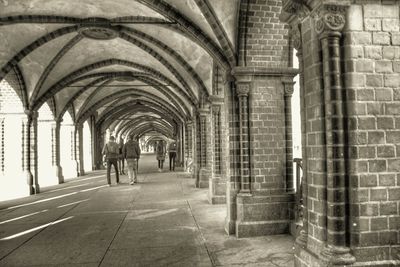 Man walking in corridor of historic building
