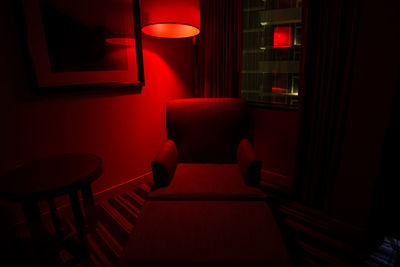 Empty chair in illuminated room