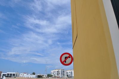 Low angle view of road sign against sky