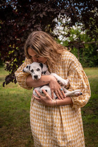 Young woman with a dalmatian puppy