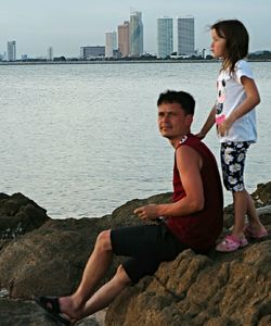 Portrait of young man sitting in water