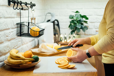 How to dry orange slices for holiday decor. process of drying orange slices in the oven. woman