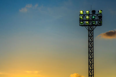 Low angle view of floodlight against sky during sunset