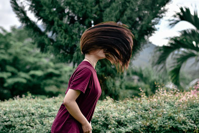 Side view of girl standing on field