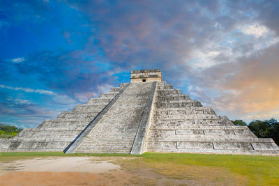 Low angle view of historical building against cloudy sky