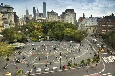 High angle view of people on city street by buildings