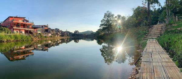 Panoramic view of lake and buildings against sky