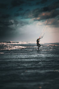 Man surfing on sea against sky