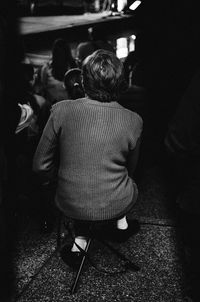Rear view of a girl sitting on floor