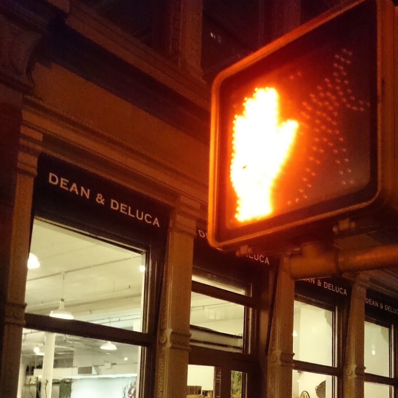 LOW ANGLE VIEW OF ILLUMINATED TEXT ON GLASS WINDOW AT RAILROAD STATION