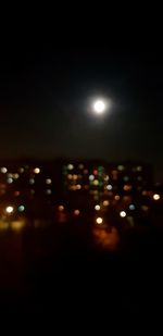 Defocused image of illuminated street lights at night