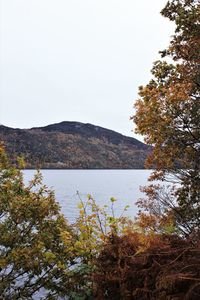 Scenic view of lake and mountains against clear sky