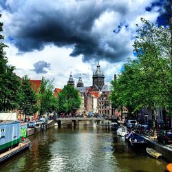 Boats in canal with buildings in background