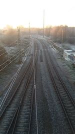 Railroad tracks against sky during winter