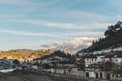 Houses in a city against sky