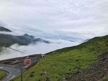 Road by mountains against sky