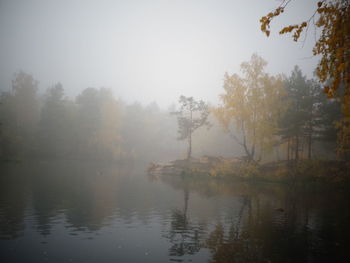 Scenic view of lake against sky during foggy weather