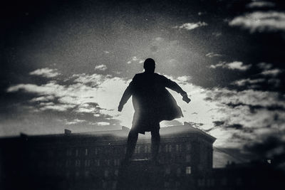 People standing against cloudy sky