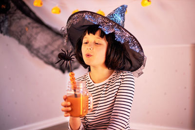 Halloween kids. a cute girl dressed as a witch