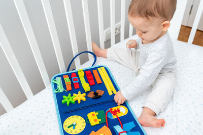 Boy playing with toy blocks at home