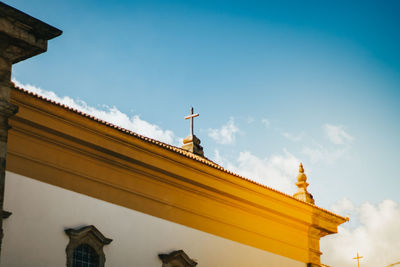 Low angle view of statues on building against sky