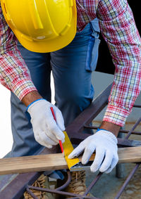 Midsection of man working on wood