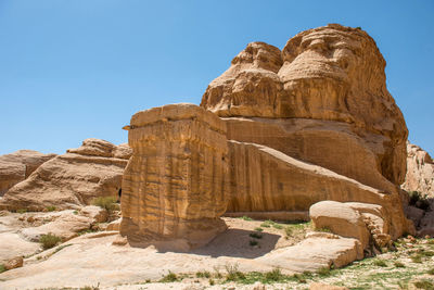 Low angle view of rock formation against clear sky