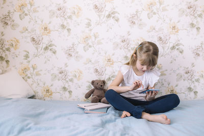 Girl sitting on bed