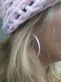 Close-up side view of woman wearing earring