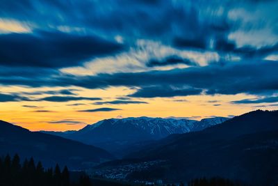 Scenic view of snowcapped mountains against sky during sunset